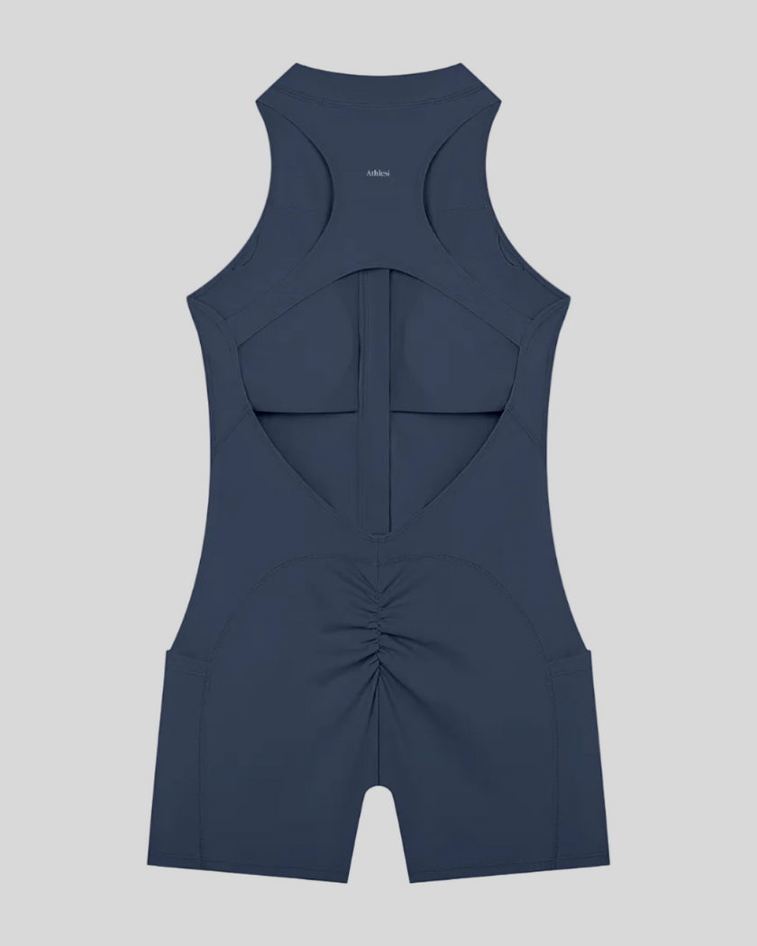 MotionFlow Yoga Romper in Navy Blue back view showcasing the open racerback design and sculpting fit