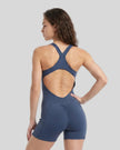 Back view of a model wearing the MotionFlow Yoga Romper in Navy Blue