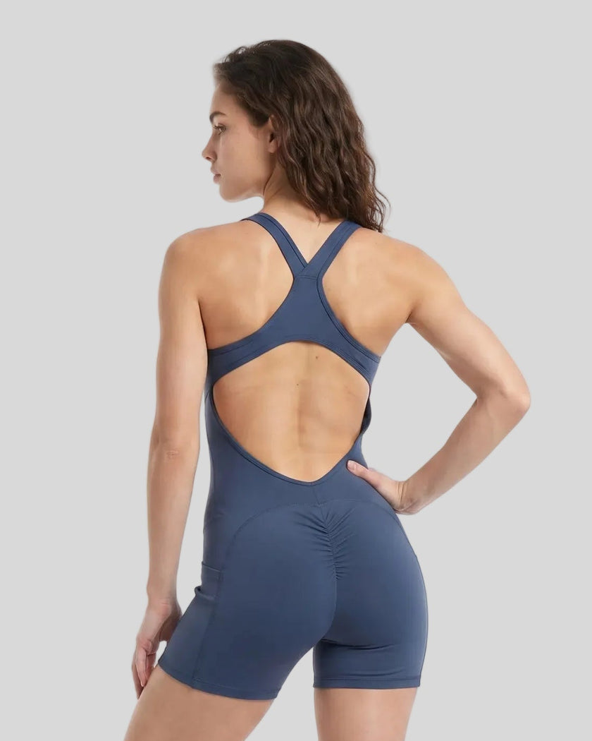 Back view of a model wearing the MotionFlow Yoga Romper in Navy Blue