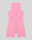 MotionFlow Yoga Romper in Pink back view showcasing the open racerback design and sculpting fit