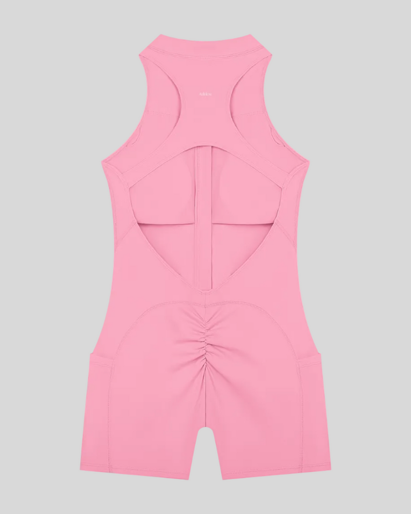 MotionFlow Yoga Romper in Pink back view showcasing the open racerback design and sculpting fit