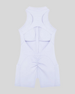MotionFlow Yoga Romper in Purple back view showcasing the open racerback design and sculpting fit