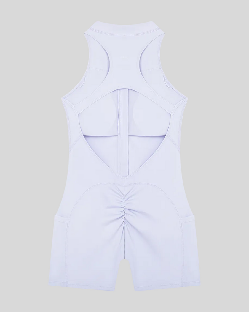 MotionFlow Yoga Romper in Purple back view showcasing the open racerback design and sculpting fit