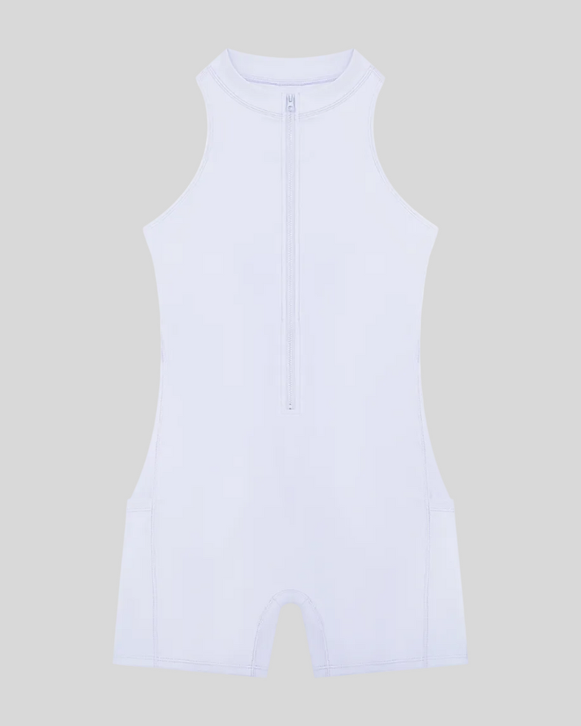 MotionFlow Yoga Romper in Purple front view featuring a mock neck, quarter-zip front, and above-the-knee silhouette