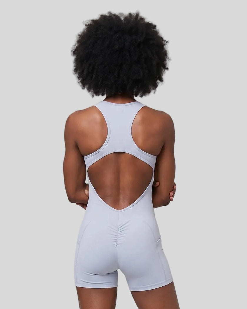 Back view of a model wearing the MotionFlow Yoga Romper in Purple