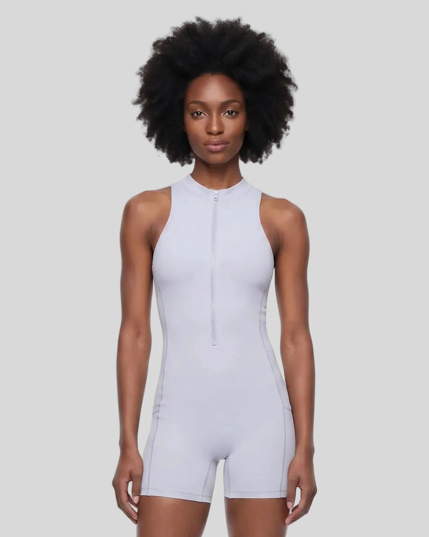Model wearing the MotionFlow Yoga Romper in Purple viewed from the front