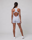 Full body back view of model wearing the MotionFlow Yoga Romper in Purple.