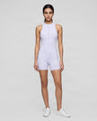 Full body front view of model wearing the MotionFlow Yoga Romper in Purple.