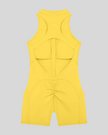 MotionFlow Yoga Romper in Yellow back view showcasing the open racerback design and sculpting fit