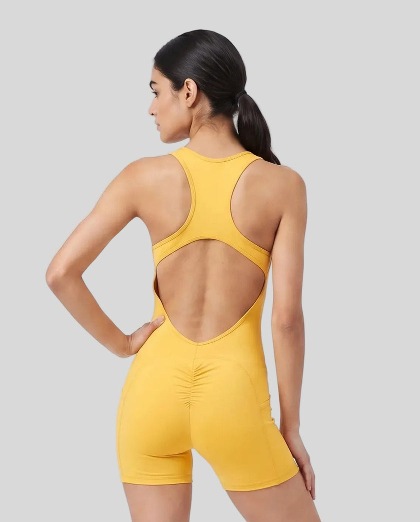 Back view of a model wearing the MotionFlow Yoga Romper in Yellow