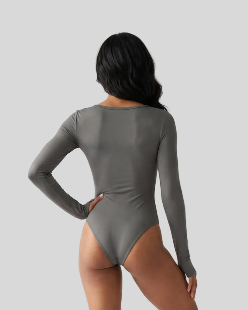Model wearing the Athlesi MotionForm Long Sleeve Bodysuit in Gray, back view highlighting the smooth fitted silhouette