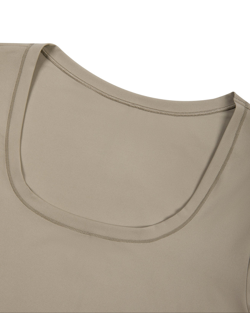 Front neckline close-up of the Athlesi MotionForm Long Sleeve Bodysuit in Khaki showing the softly curved U-neck.