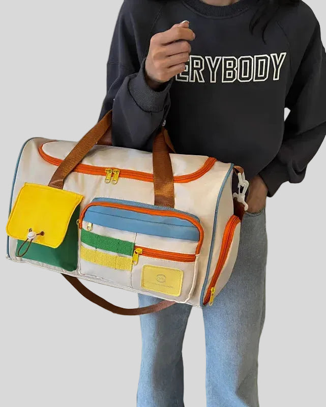 Model carrying MotionPlay Travel Bag on forearm showing structured design and portability
