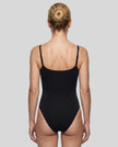 Woman wearing the MotionZip Ruched Bodysuit in Black from the back showing its streamlined fit and adjustable straps