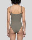 Woman wearing the MotionZip Ruched Bodysuit in Gray from the back showing its streamlined fit and adjustable straps