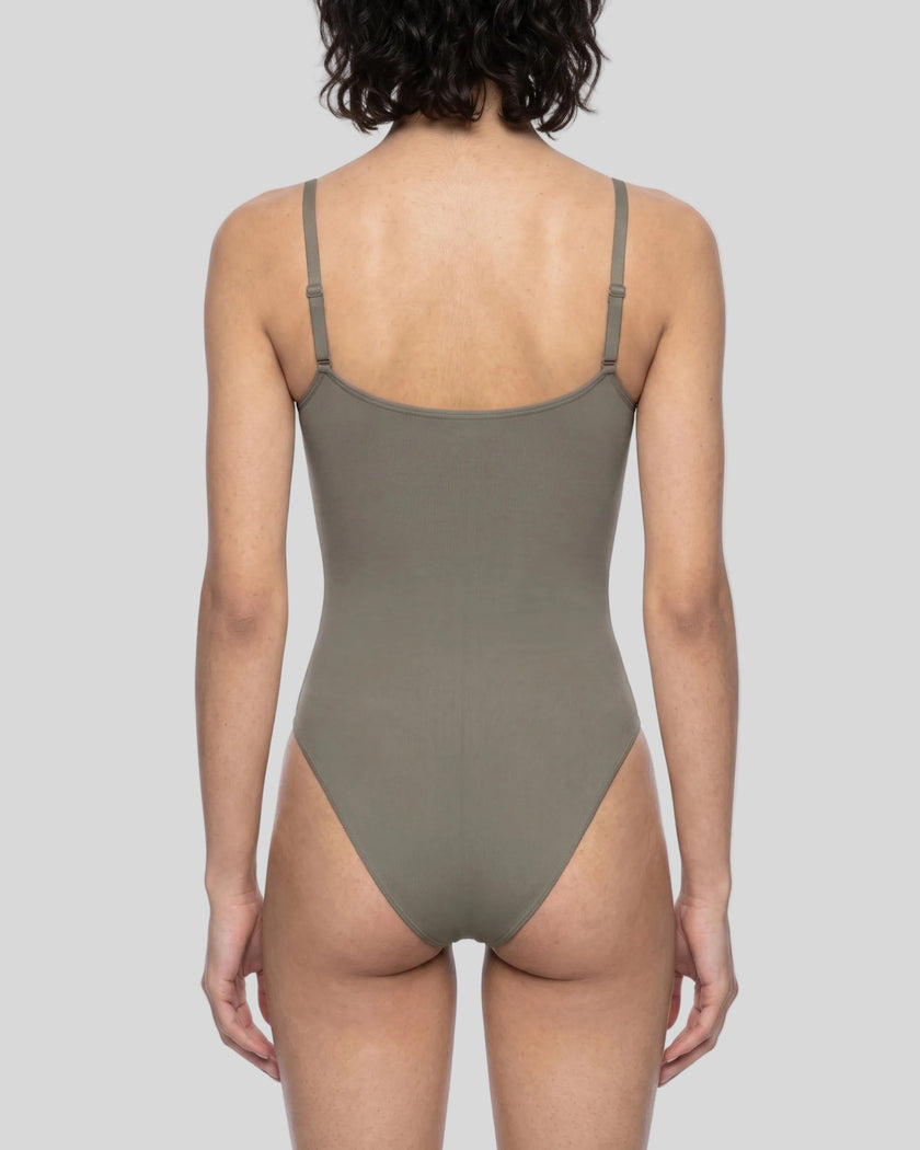 Woman wearing the MotionZip Ruched Bodysuit in Gray from the back showing its streamlined fit and adjustable straps