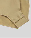 Close-up of MotionZip Ruched Bodysuit in Khaki showing convenient snap-button crotch closure