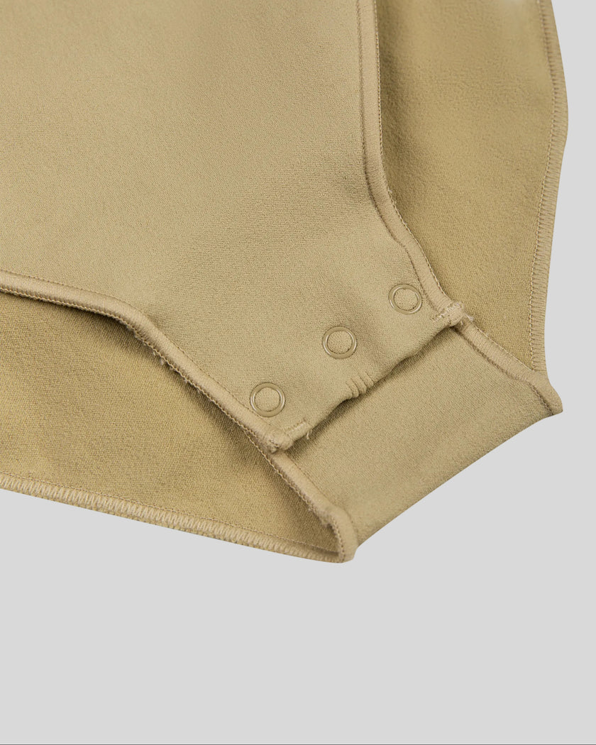 Close-up of MotionZip Ruched Bodysuit in Khaki showing convenient snap-button crotch closure