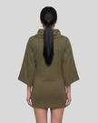 Mid body back view of woman wearing Muse Cowl Tunic in army green