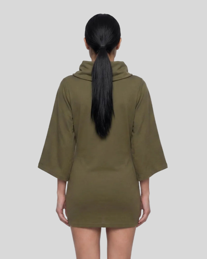 Mid body back view of woman wearing Muse Cowl Tunic in army green