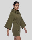 Mid body side view showing the draped neckline and wide sleeve silhouette in army green