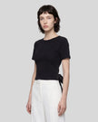 Angled upper body front view of woman wearing Nova Tie-Back Tee in black with contrasting Black tie detail