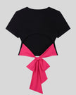 Back view of Nova Tie-Back Tee in black featuring an open back and contrasting Rose Red bow