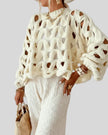Open-weave cable knit sweater in beige showing textured knit detail, front angle