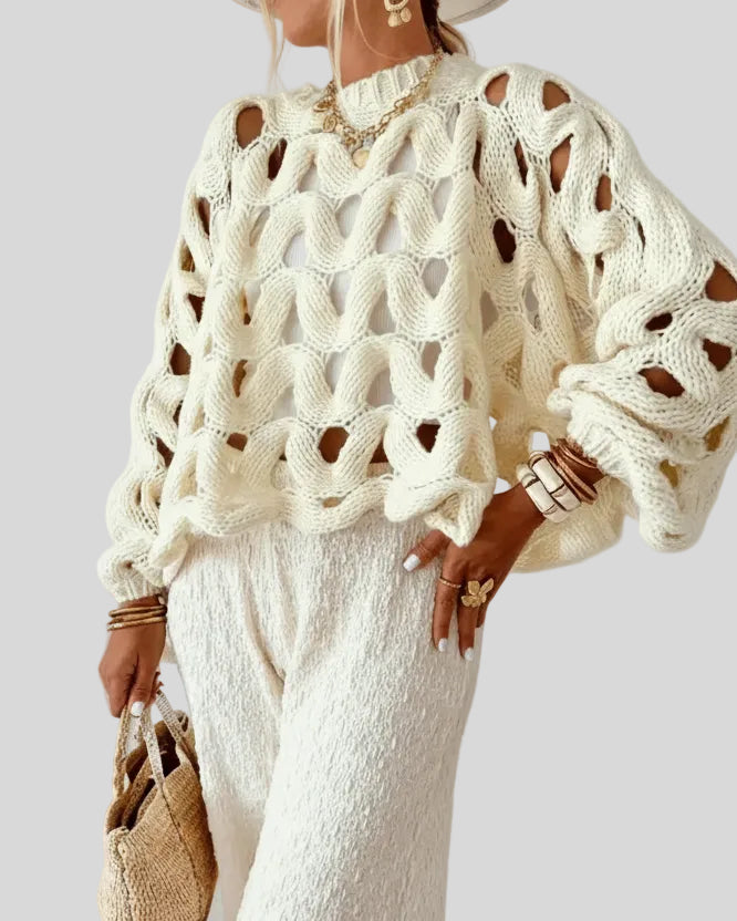 Open-weave cable knit sweater in beige showing textured knit detail, front angle