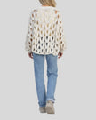 Open-weave cable knit sweater in white with relaxed fit, back view