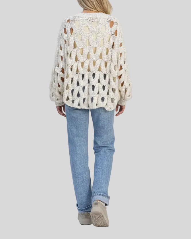 Open-weave cable knit sweater in white with relaxed fit, back view