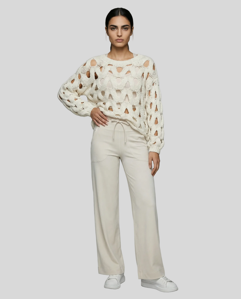 Full body front view of woman wearing white OpenWeave Cable Sweater with ivory active pants