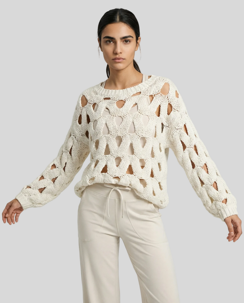 Mid body front closeup view of woman wearing white OpenWeave Cable Sweater with ivory active pants