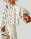 Lightweight cable knit sweater in white with open weave, side view