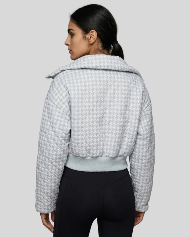 Model wearing cropped houndstooth jacket back view styled with activewear look