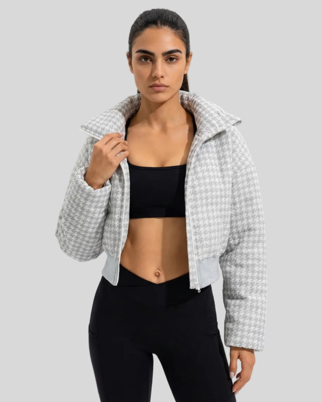 Model wearing cropped houndstooth jacket open styled with activewear set mid body view