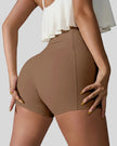 Back right view of chestnut seamless studio short with waistband pocket