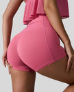 Back right closeup view of deep pink seamless studio short with waistband pocket