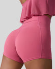 Back right view of deep pink seamless studio short with waistband pocket