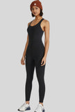 Front angle view of Athlesi PowerFlow open-back active jumpsuit in black