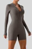 Front angle view of Athlesi PowerSculpt long sleeve romper in dark gray