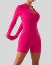 Front angle view of Athlesi PowerSculpt long sleeve romper in hot pink
