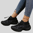 Black mesh sneakers side view showing sculpted sole and breathable upper design
