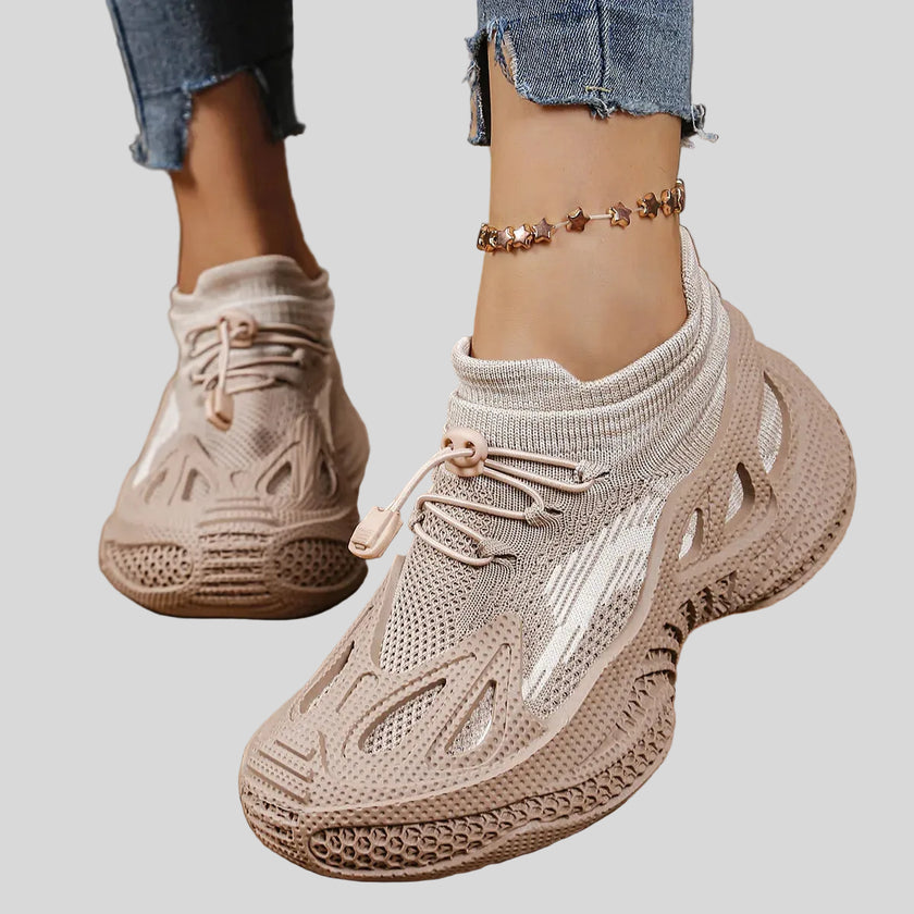 Close-up of khaki mesh sneakers highlighting texture, ventilation, and sculpted sole details