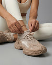 Woman adjusting khaki Pulseform Mesh Sneakers showing fit and breathable mesh upper detail