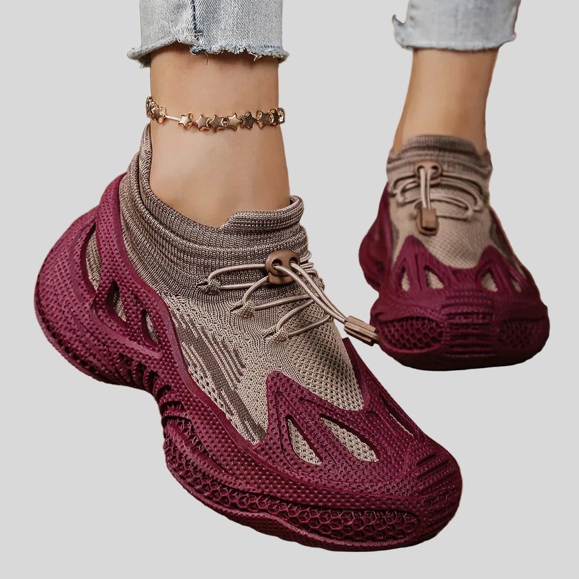 Close-up of purple mesh sneakers highlighting texture, ventilation, and sculpted sole details