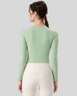Back view of light green PulseMesh Studio Top with long sleeves