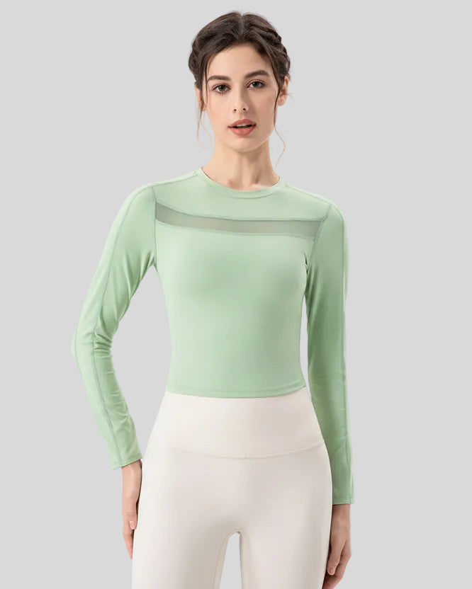 PulseMesh Studio Top in light green, front view with mesh chest detail