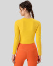 Back view of neon yellow PulseMesh Studio Top with long sleeves