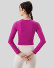 Back view of red violet PulseMesh Studio Top with long sleeves